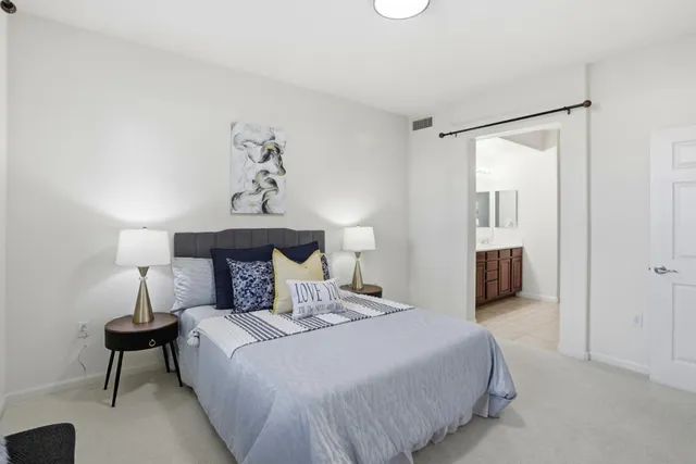 a bedroom with a bed and a table