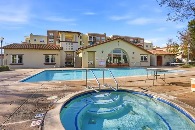 a view of patio with table and chairs under an umbrella
