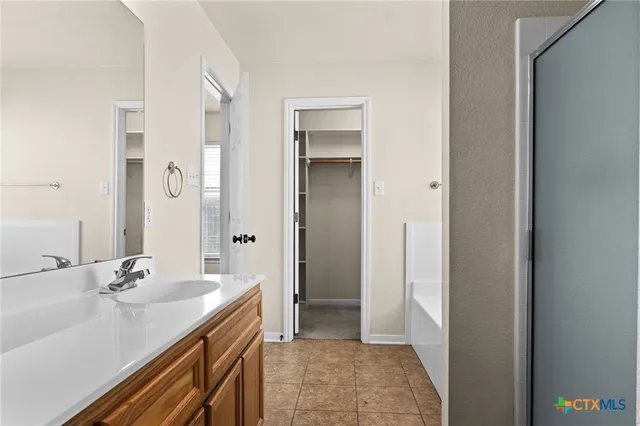 a bathroom with a sink a mirror and a shower