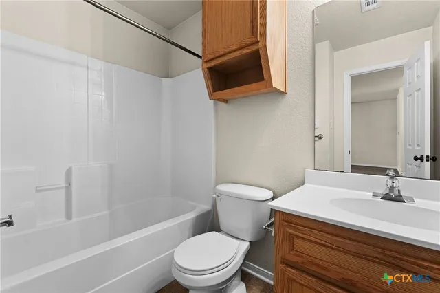 a bathroom with a sink a toilet a mirror and bathtub