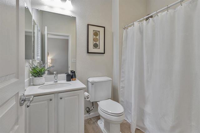 907 Rancho Place San Jose, CA 95126 - Photo 27 of 31 a bathroom with a sink a toilet and shower curtain