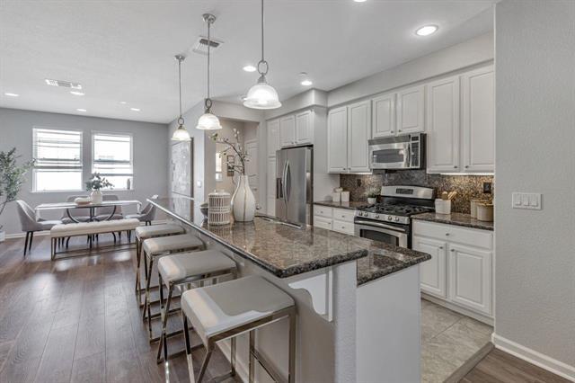 907 Rancho Place San Jose, CA 95126 - Photo 7 of 31 a kitchen with kitchen island granite countertop a sink a counter space appliances and cabinets