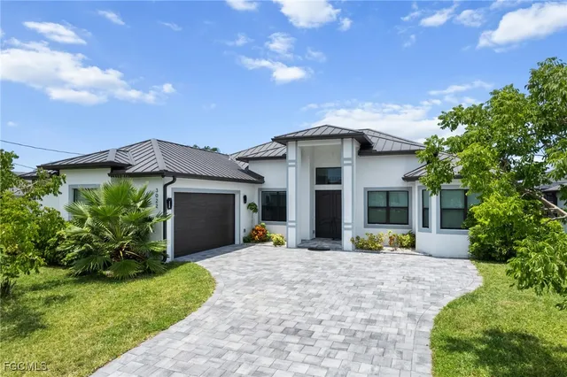 a view of a house with outdoor space and garden