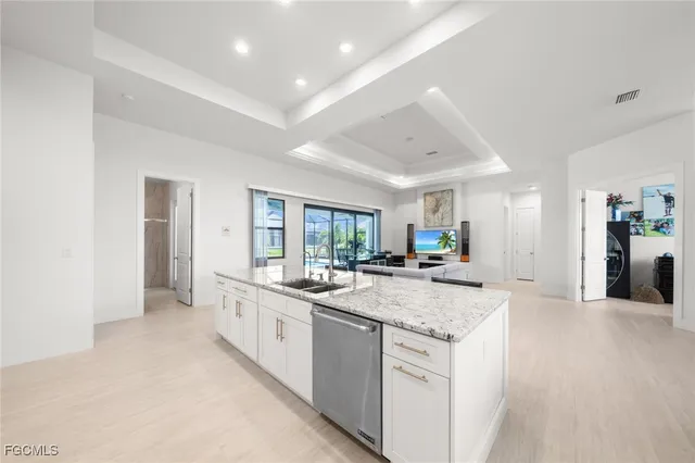 a large kitchen with sink and cabinets
