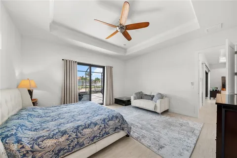 a bedroom with a bed and ceiling fan