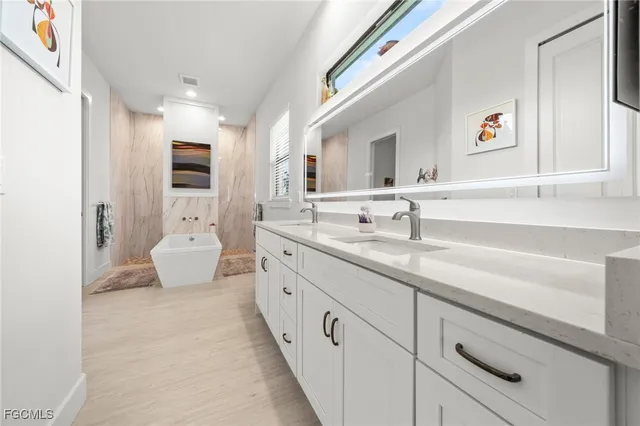 a spacious bathroom with a sink and a mirror