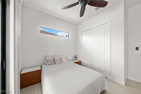 a bedroom with a bed and a chandelier