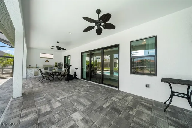 a view of a livingroom with furniture and a large window