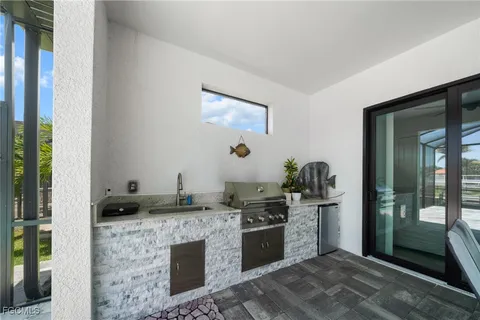 a kitchen with stainless steel appliances kitchen island granite countertop a stove a sink and a refrigerator