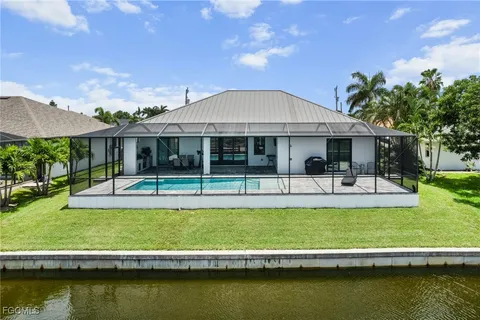 a view of a swimming pool with chair and tables