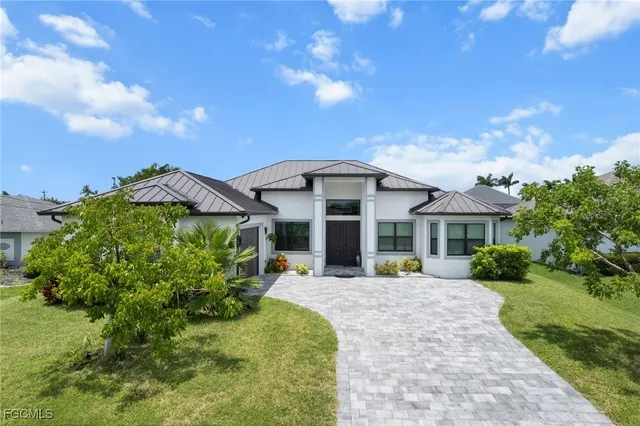 a view of a house with outdoor space and garden