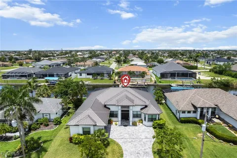 an aerial view of multiple houses with a yard