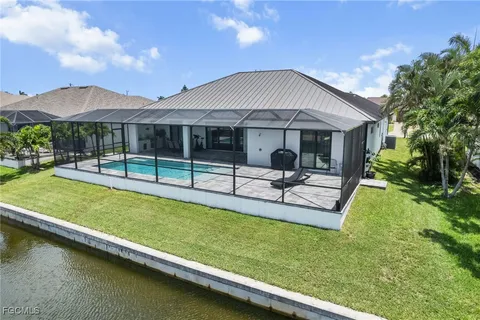 a backyard of a house with table and chairs