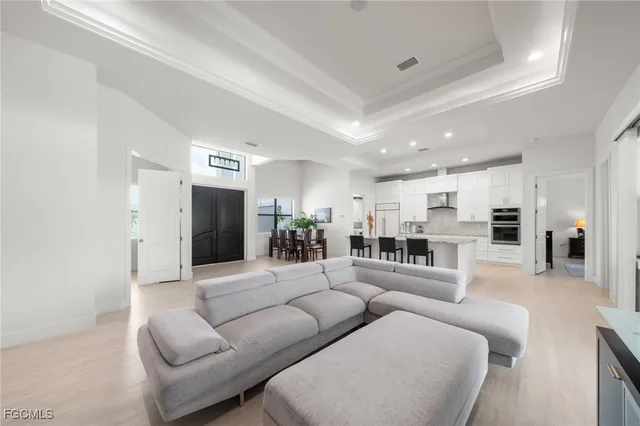 a living room with furniture and view of kitchen