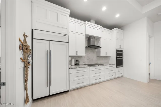 a kitchen with stainless steel appliances a refrigerator sink and cabinets