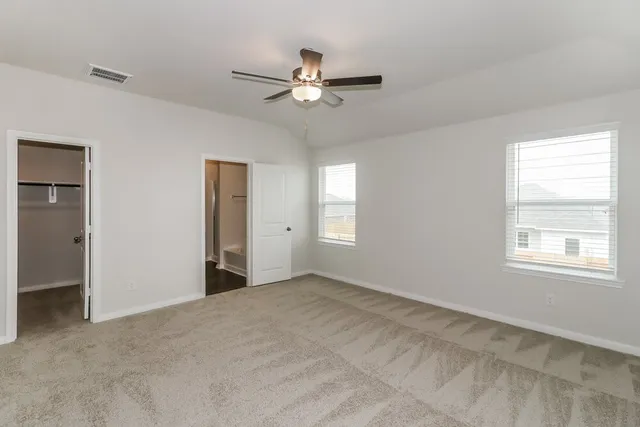 a view of a livingroom with a ceiling fan and window