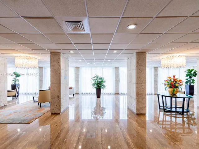 a view of a hallway with wooden floor and furniture