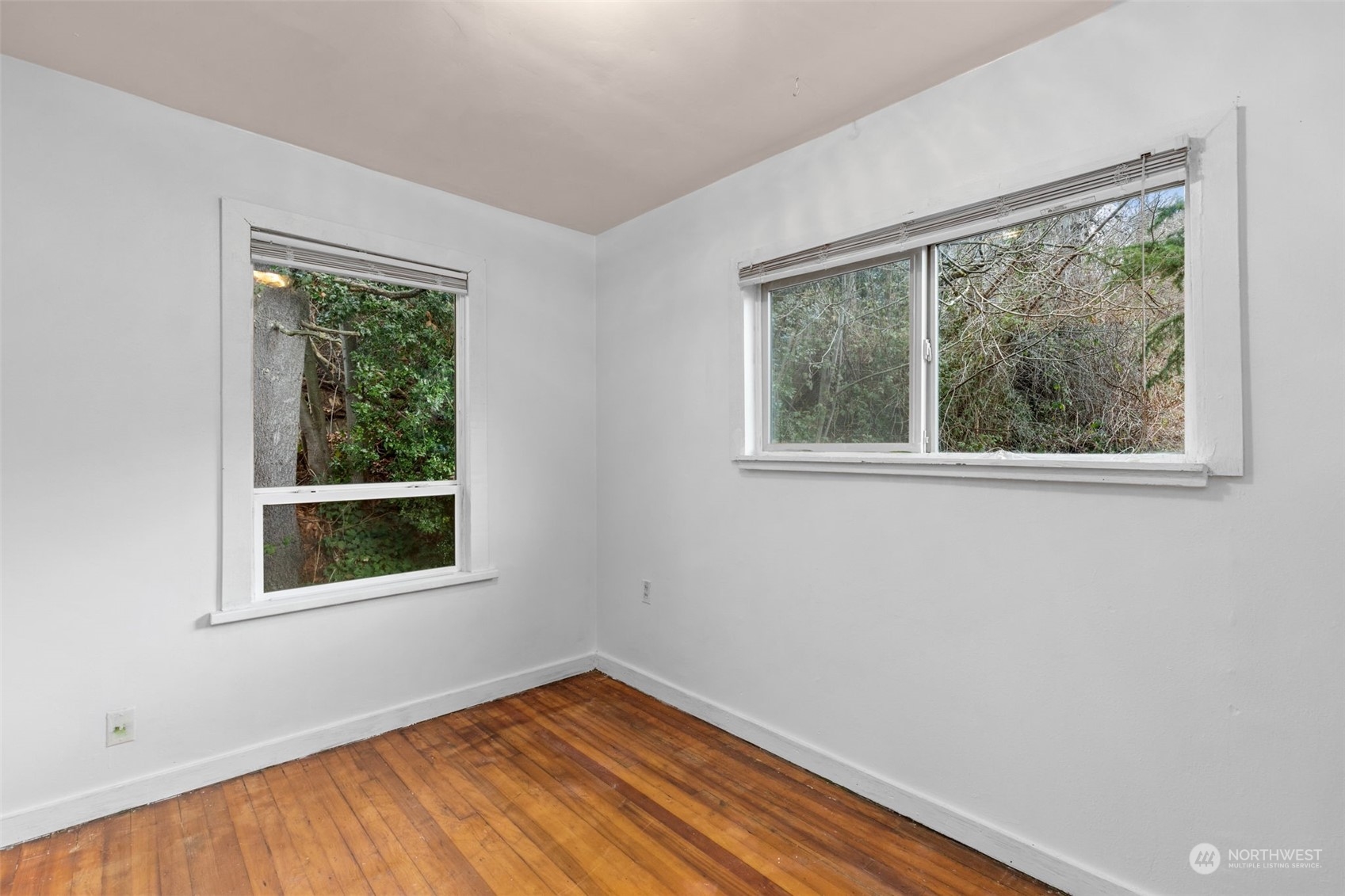 666 Sunset Boulevard Northeast Renton, WA 98056 - Photo 17 of 39 a view of an empty room with wooden floor and a window