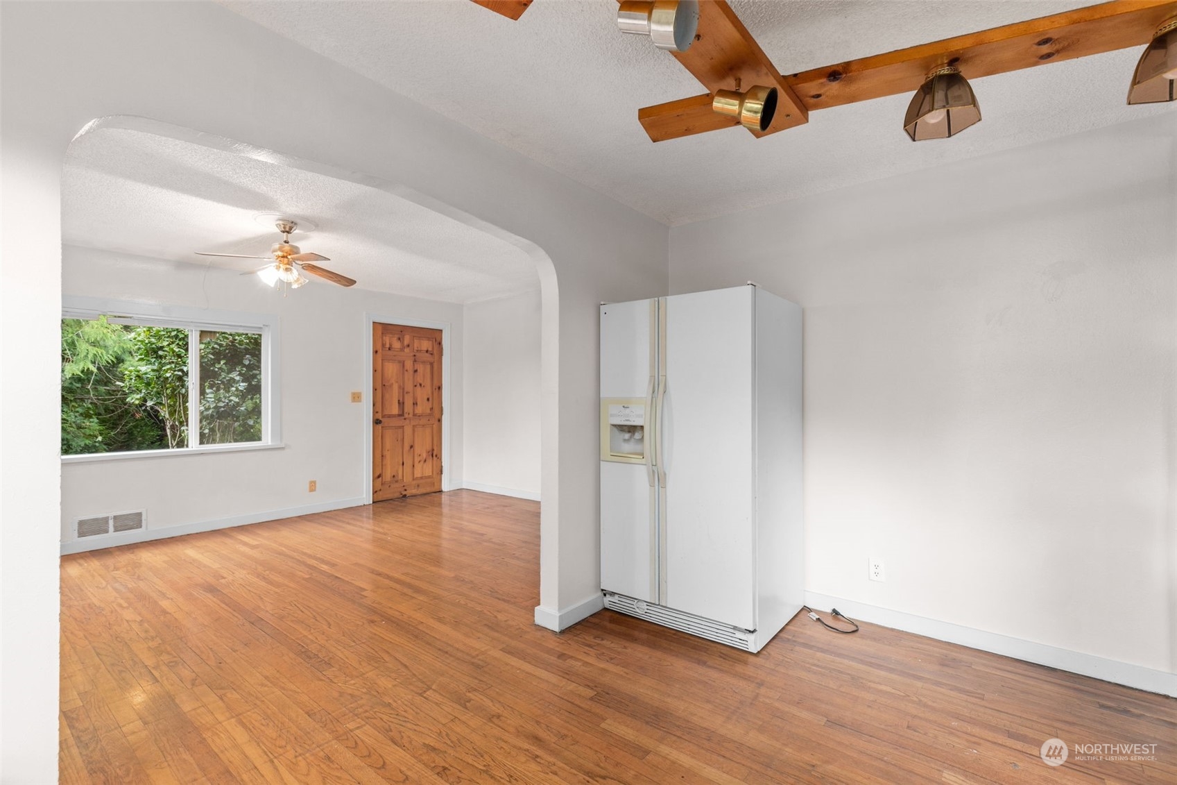 666 Sunset Boulevard Northeast Renton, WA 98056 - Photo 9 of 39 a view of an empty room with wooden floor and a window