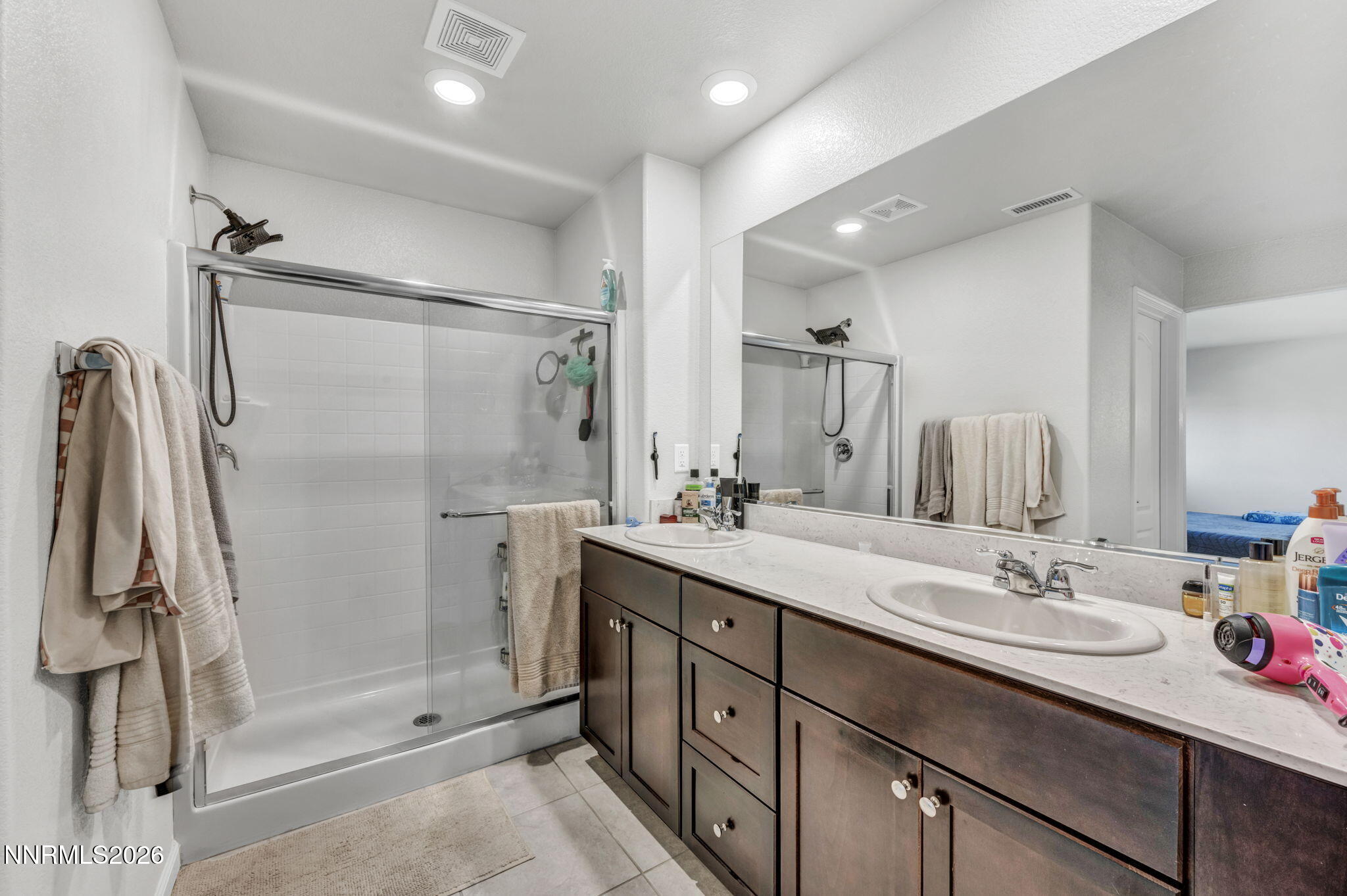 8850 Finnsech Drive Reno, NV 89506 - Photo 13 of 56 a bathroom with a double vanity sink mirror and shower