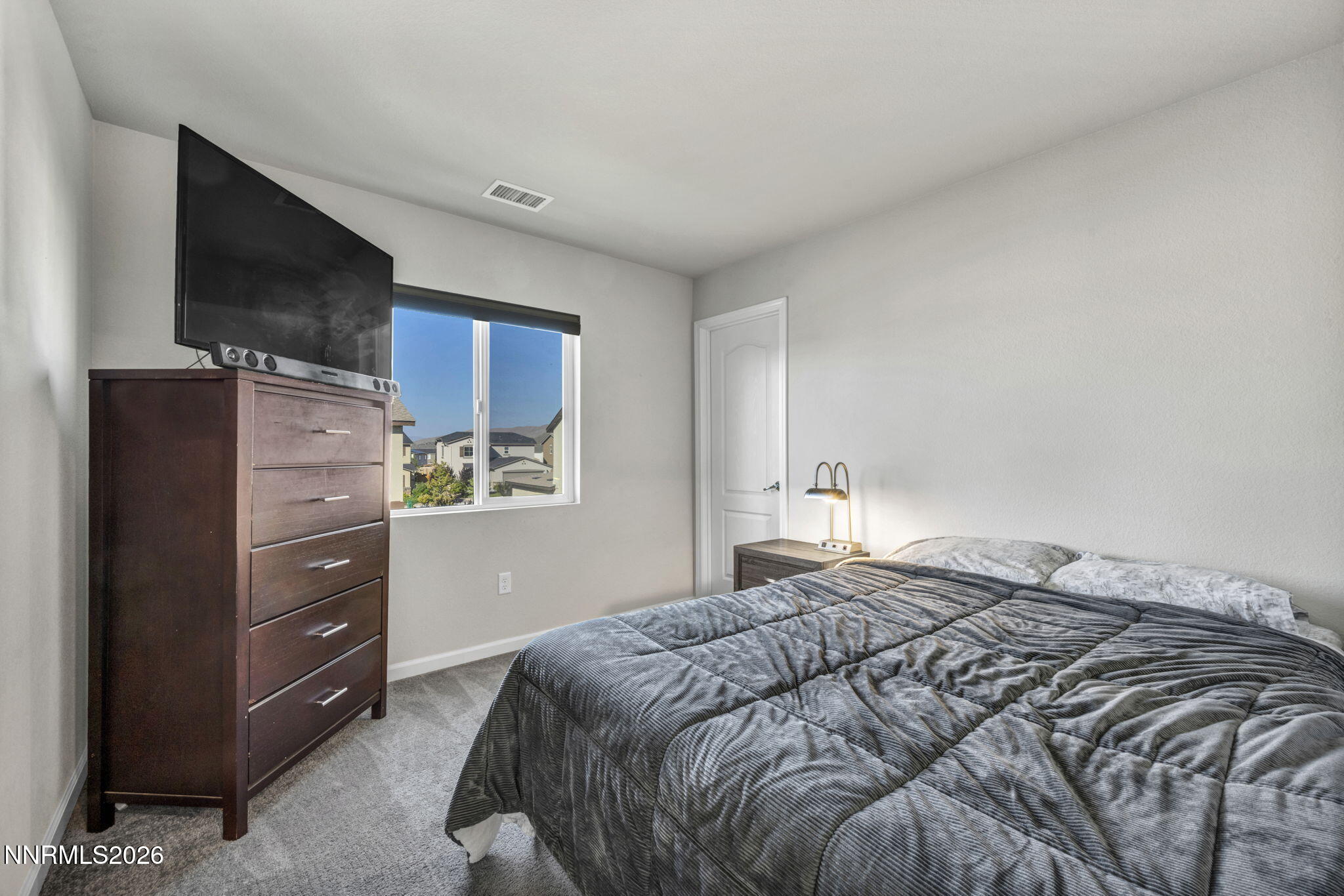 8850 Finnsech Drive Reno, NV 89506 - Photo 25 of 56 a bedroom with a bed and a flat screen tv