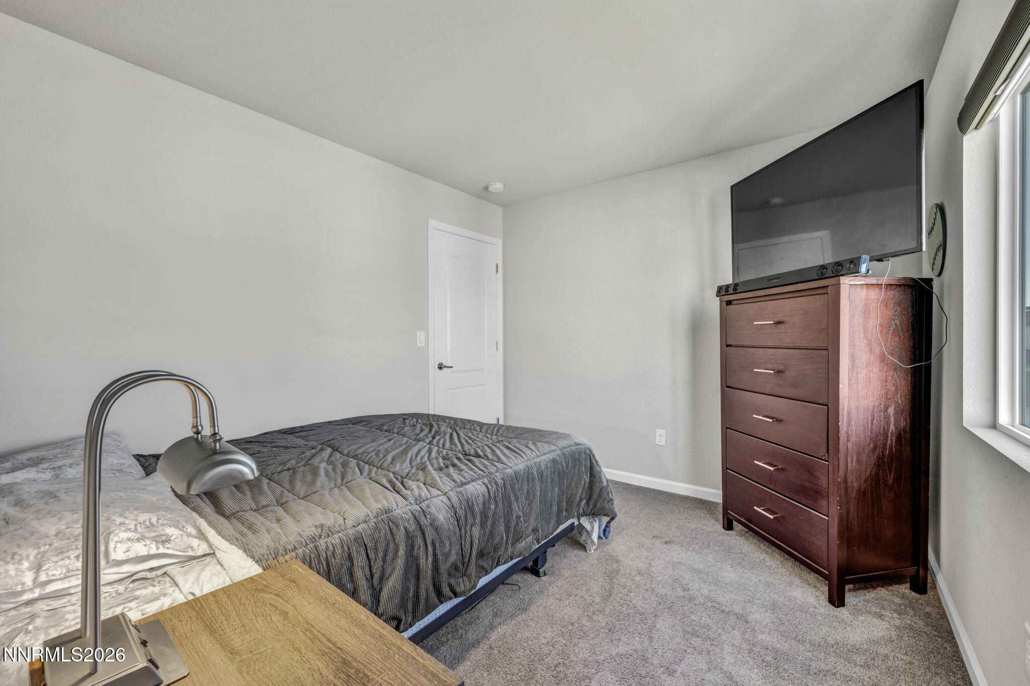 8850 Finnsech Drive Reno, NV 89506 - Photo 26 of 56 a bedroom with a bed and a dresser