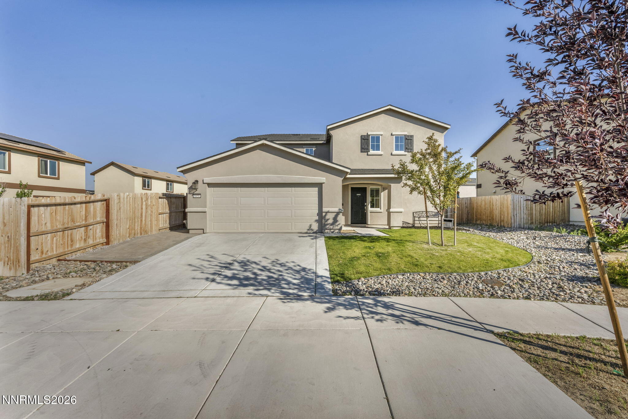 8850 Finnsech Drive Reno, NV 89506 - Photo 38 of 56 a front view of a house with a yard and garage