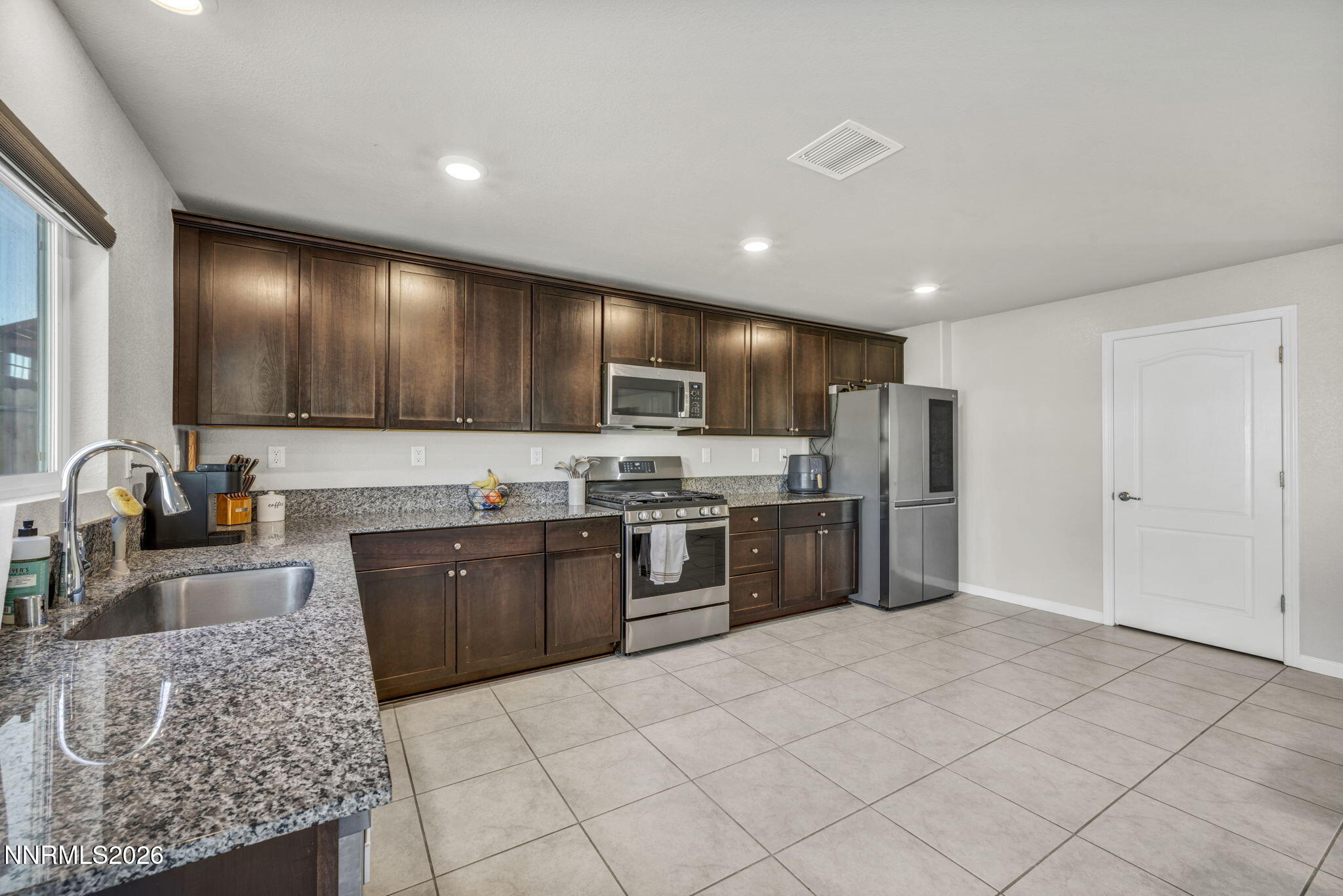 8850 Finnsech Drive Reno, NV 89506 - Photo 52 of 56 a large kitchen with stainless steel appliances lots of counter top space cabinets and a sink