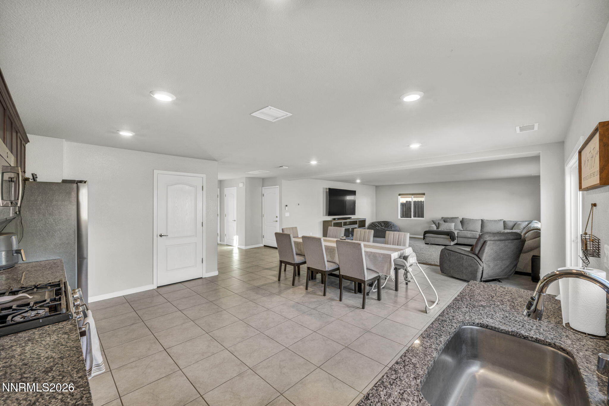 8850 Finnsech Drive Reno, NV 89506 - Photo 6 of 56 a living room with furniture a large window and a dining table