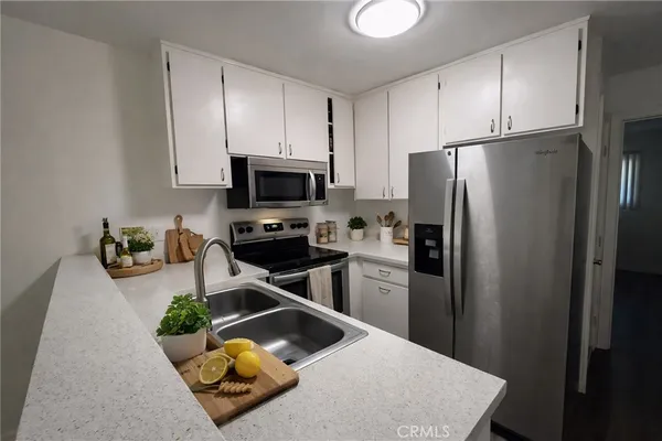 a view of a kitchen with a sink and cabinets