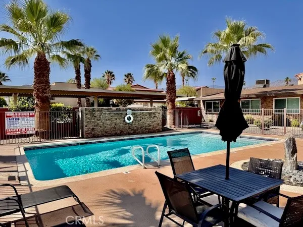 a view of a patio with table and chairs and potted plants