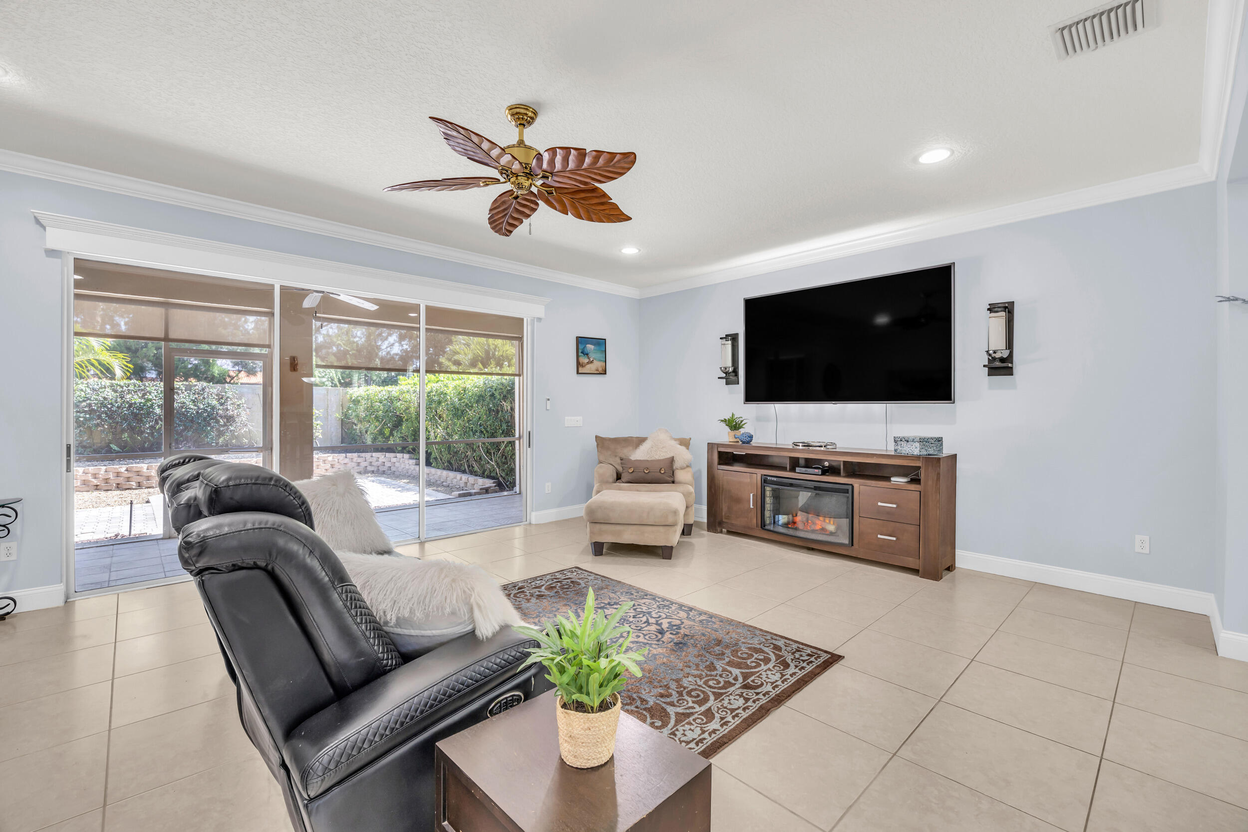 148 Cypress Cove Jupiter, FL 33458 - Photo 13 of 53 a living room with furniture a flat screen tv and a large window
