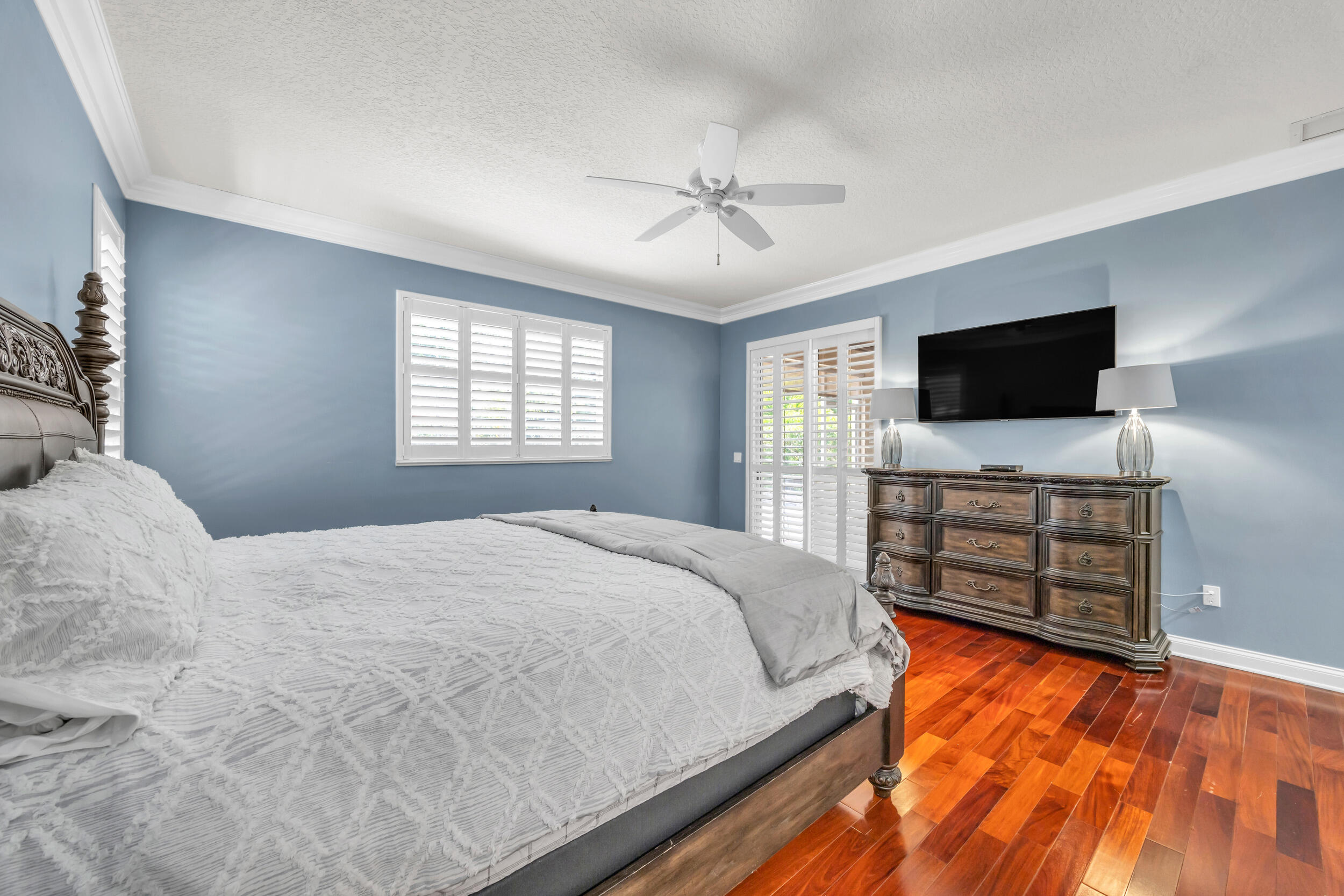148 Cypress Cove Jupiter, FL 33458 - Photo 19 of 53 a bedroom with a bed and a flat screen tv