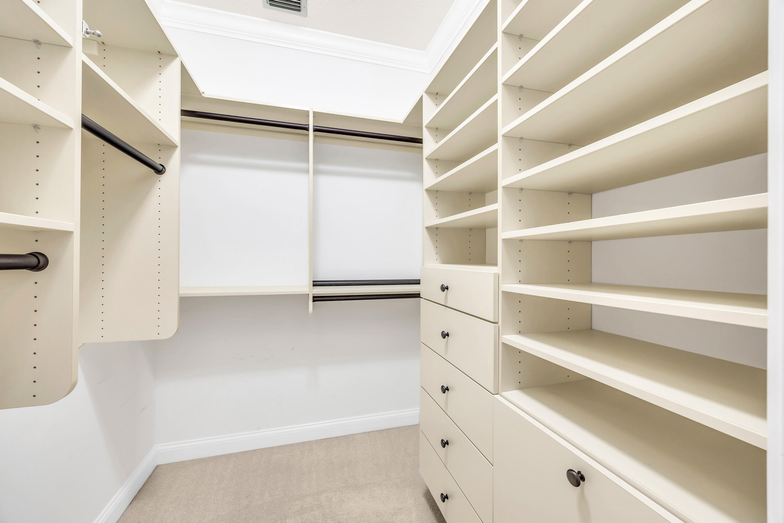 148 Cypress Cove Jupiter, FL 33458 - Photo 20 of 53 a view of walk in closet with empty racks