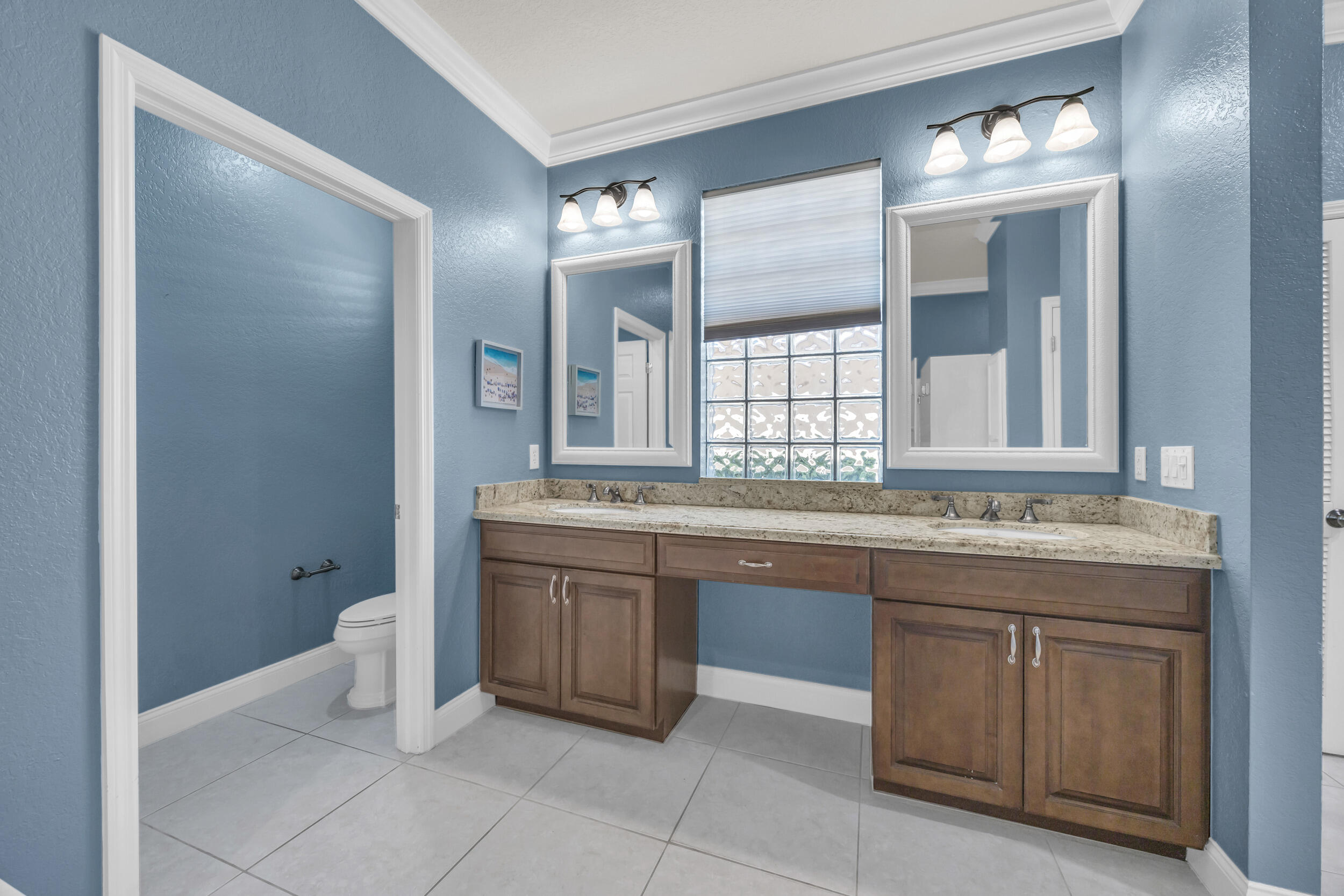 148 Cypress Cove Jupiter, FL 33458 - Photo 21 of 53 a bathroom with a granite countertop sink and a mirror
