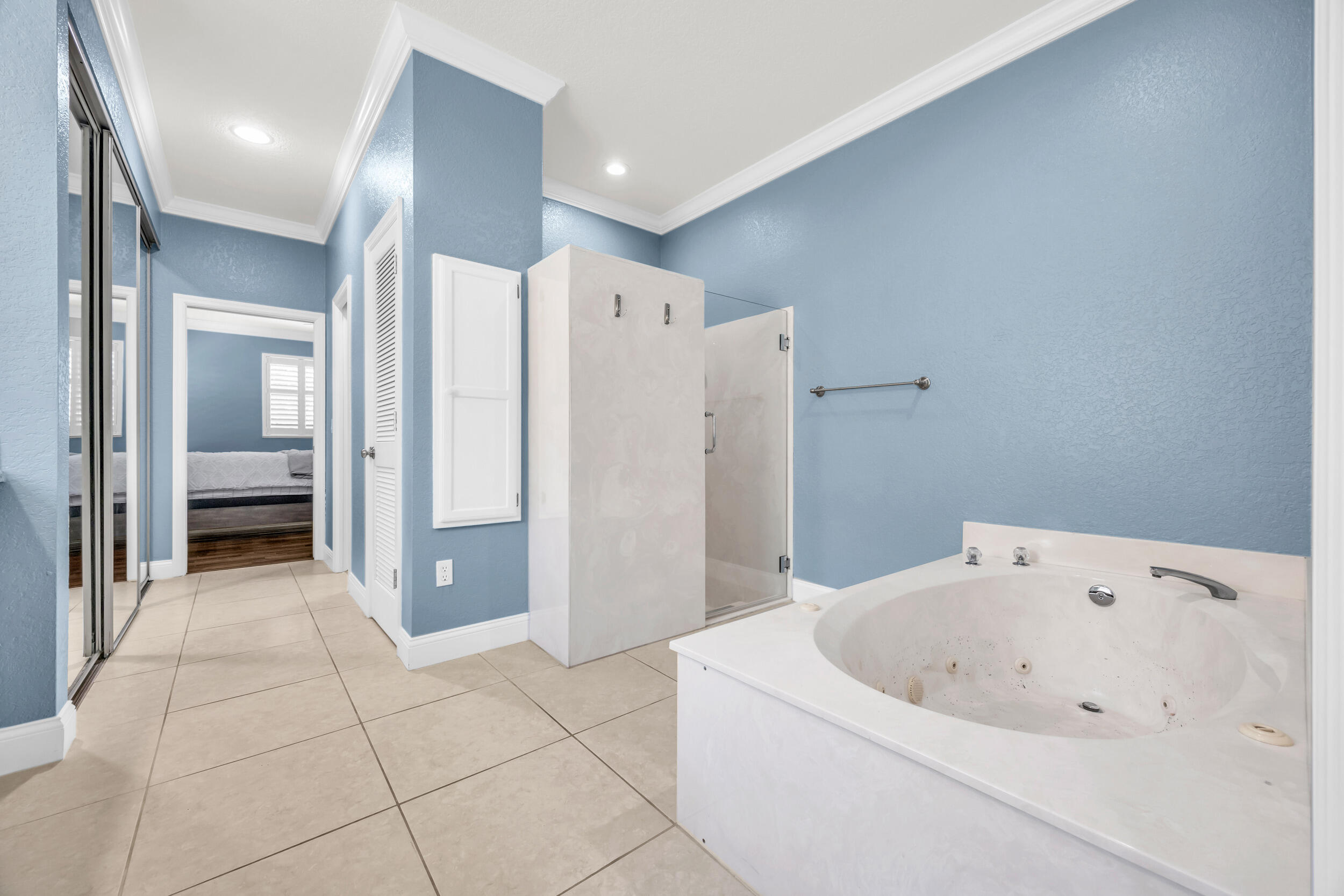 148 Cypress Cove Jupiter, FL 33458 - Photo 23 of 53 a bathroom with a bathtub and a shower