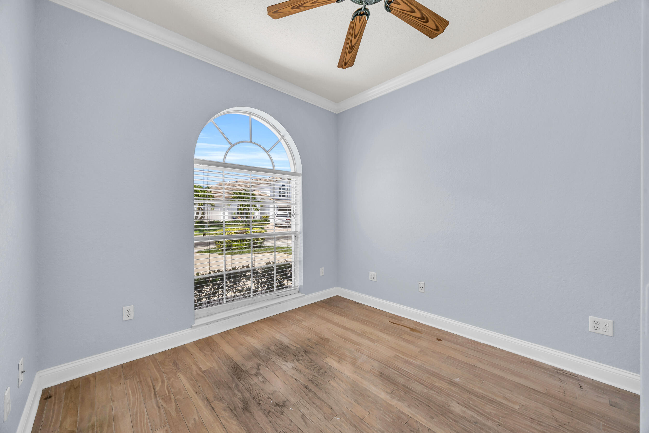 148 Cypress Cove Jupiter, FL 33458 - Photo 25 of 53 an empty room with ceiling fan and window