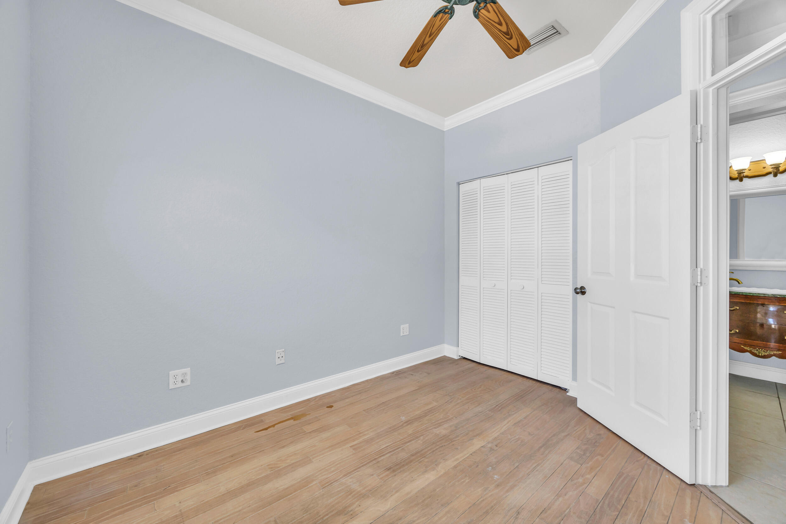 148 Cypress Cove Jupiter, FL 33458 - Photo 26 of 53 an empty room with a ceiling fan and wooden floor