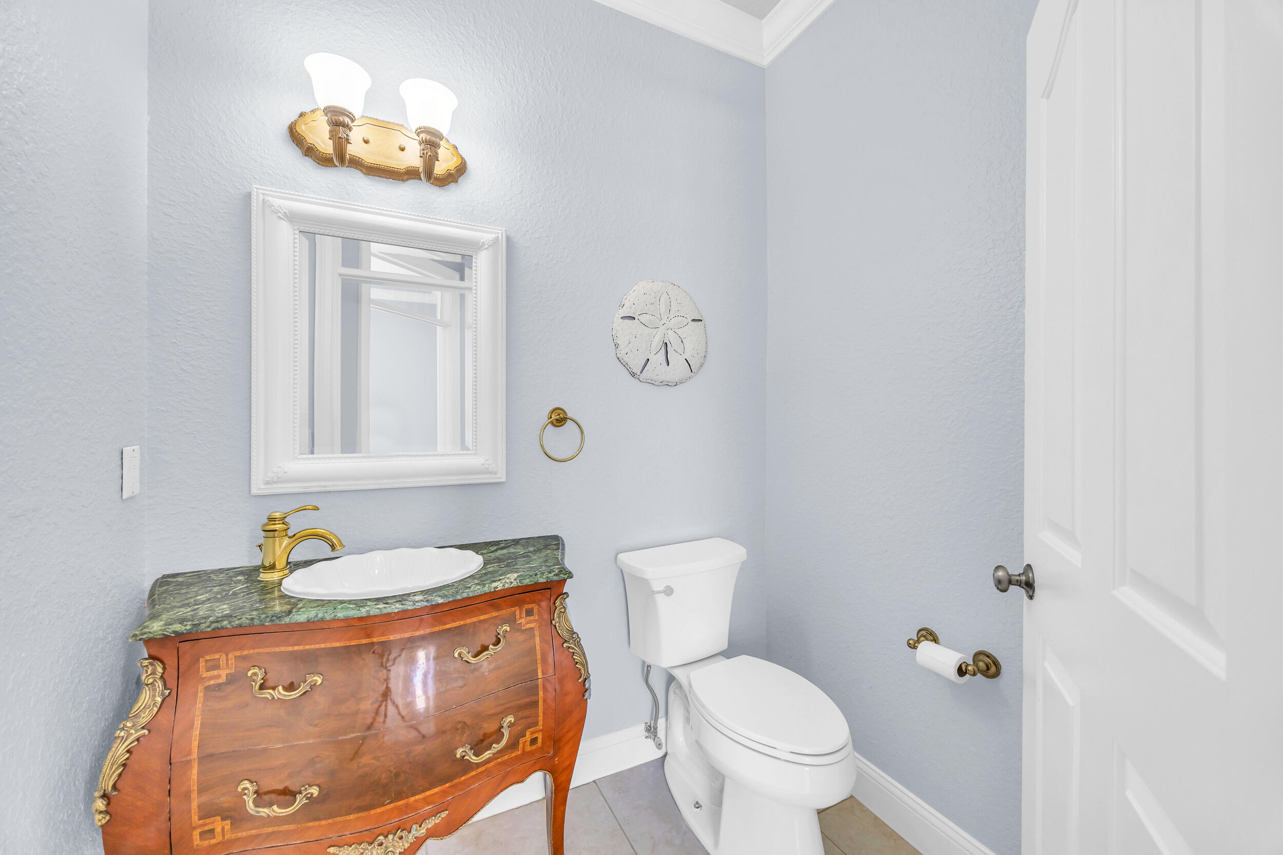 148 Cypress Cove Jupiter, FL 33458 - Photo 28 of 53 a bathroom with a toilet and a sink