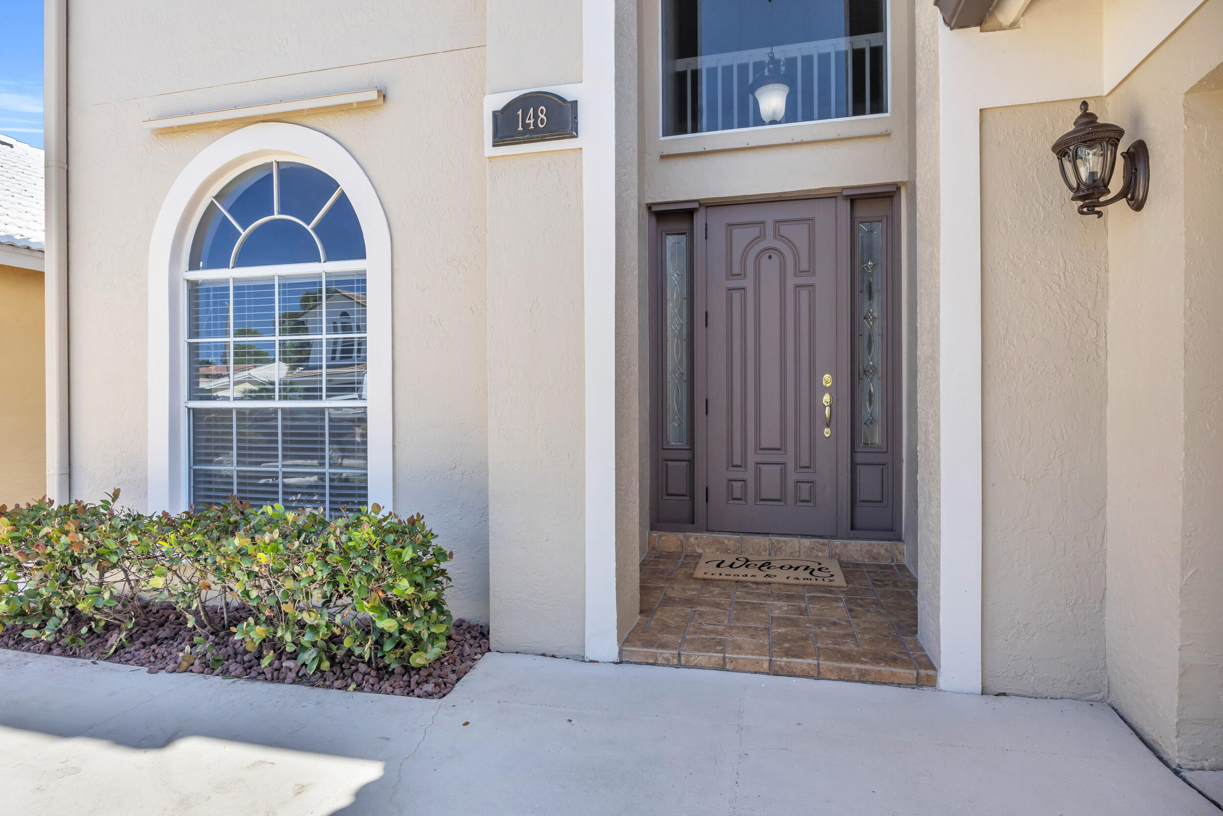 148 Cypress Cove Jupiter, FL 33458 - Photo 3 of 53 a front view of a house with garden