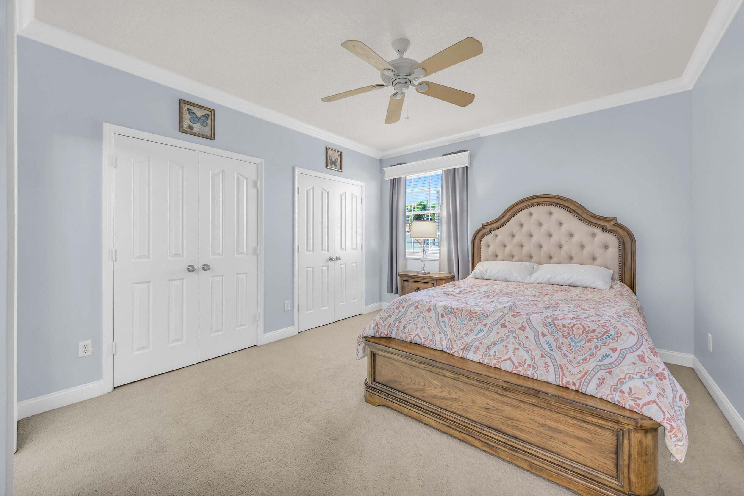 148 Cypress Cove Jupiter, FL 33458 - Photo 33 of 53 a bedroom with a bed and a chandelier