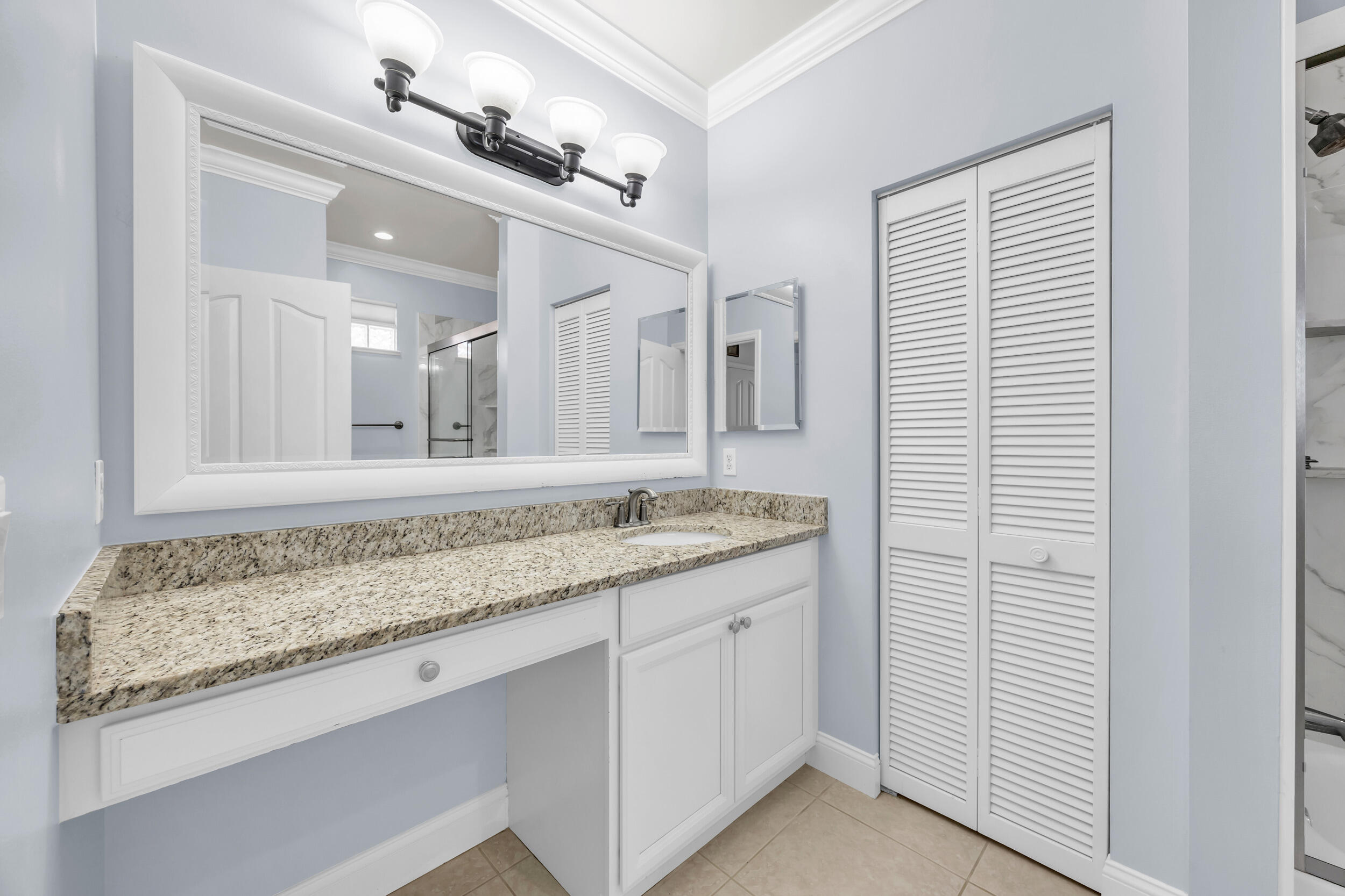 148 Cypress Cove Jupiter, FL 33458 - Photo 36 of 53 a bathroom with a granite countertop sink and a mirror