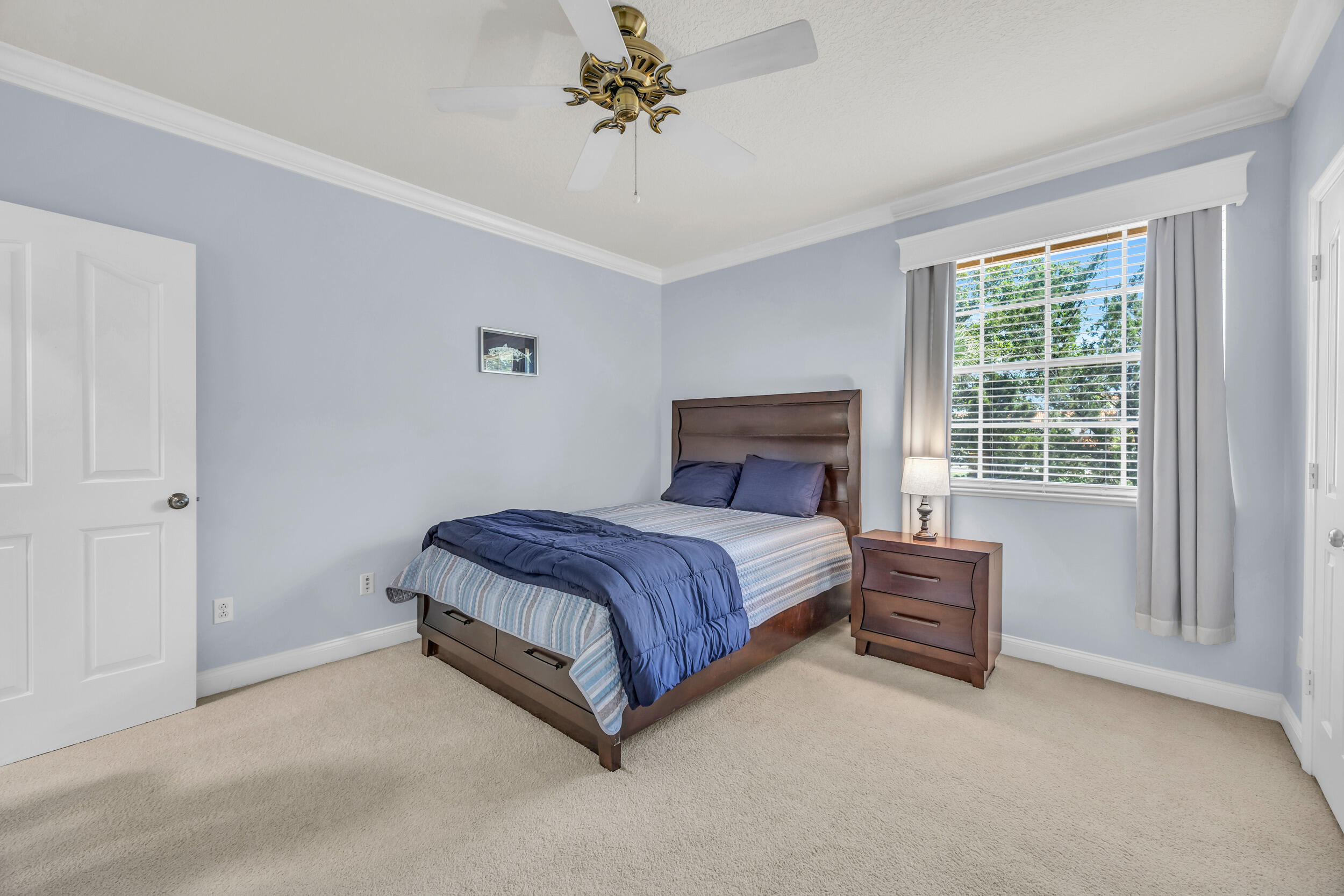 148 Cypress Cove Jupiter, FL 33458 - Photo 39 of 53 a bed sitting in a bedroom next to a window