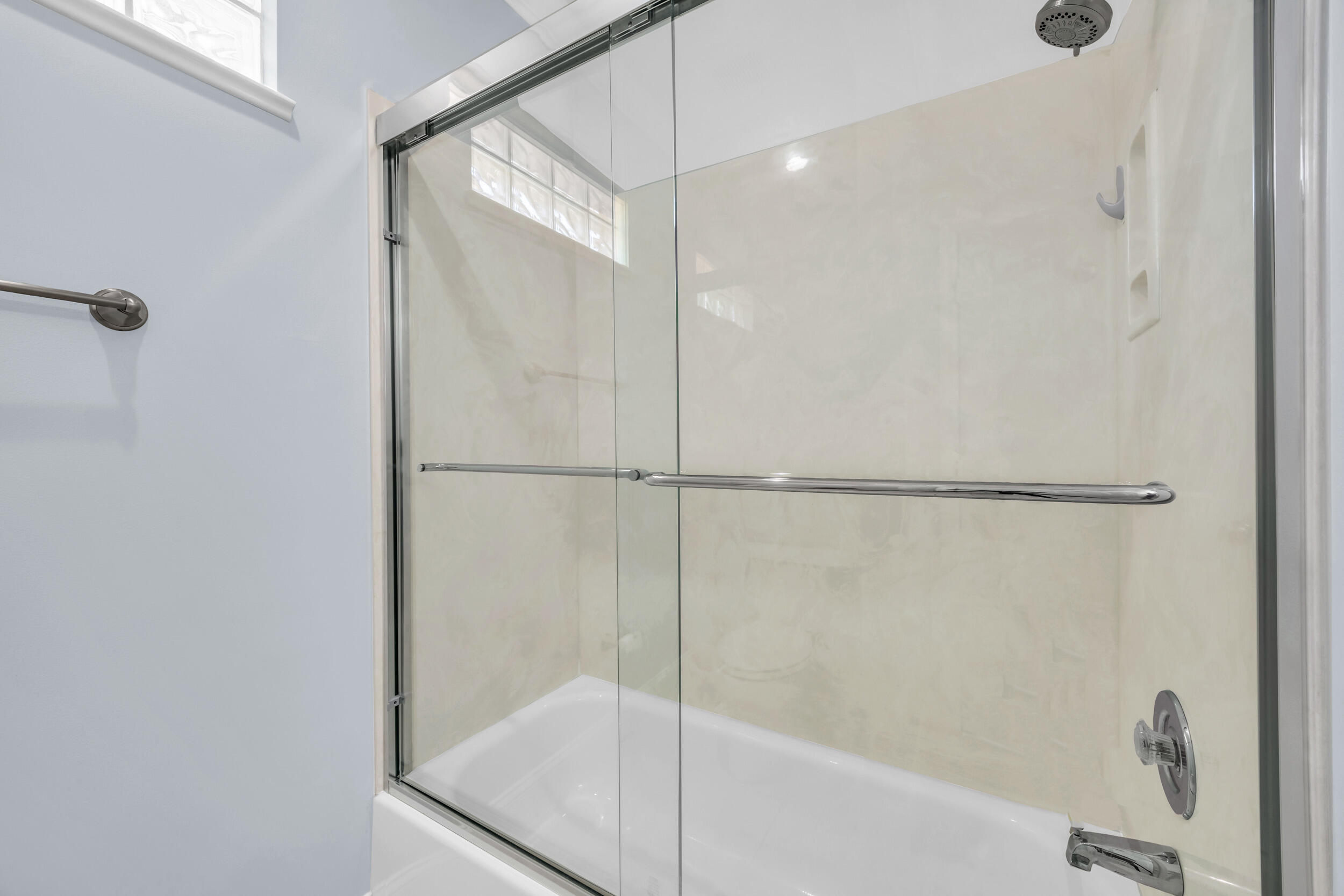 148 Cypress Cove Jupiter, FL 33458 - Photo 41 of 53 a bathroom with a glass shower door