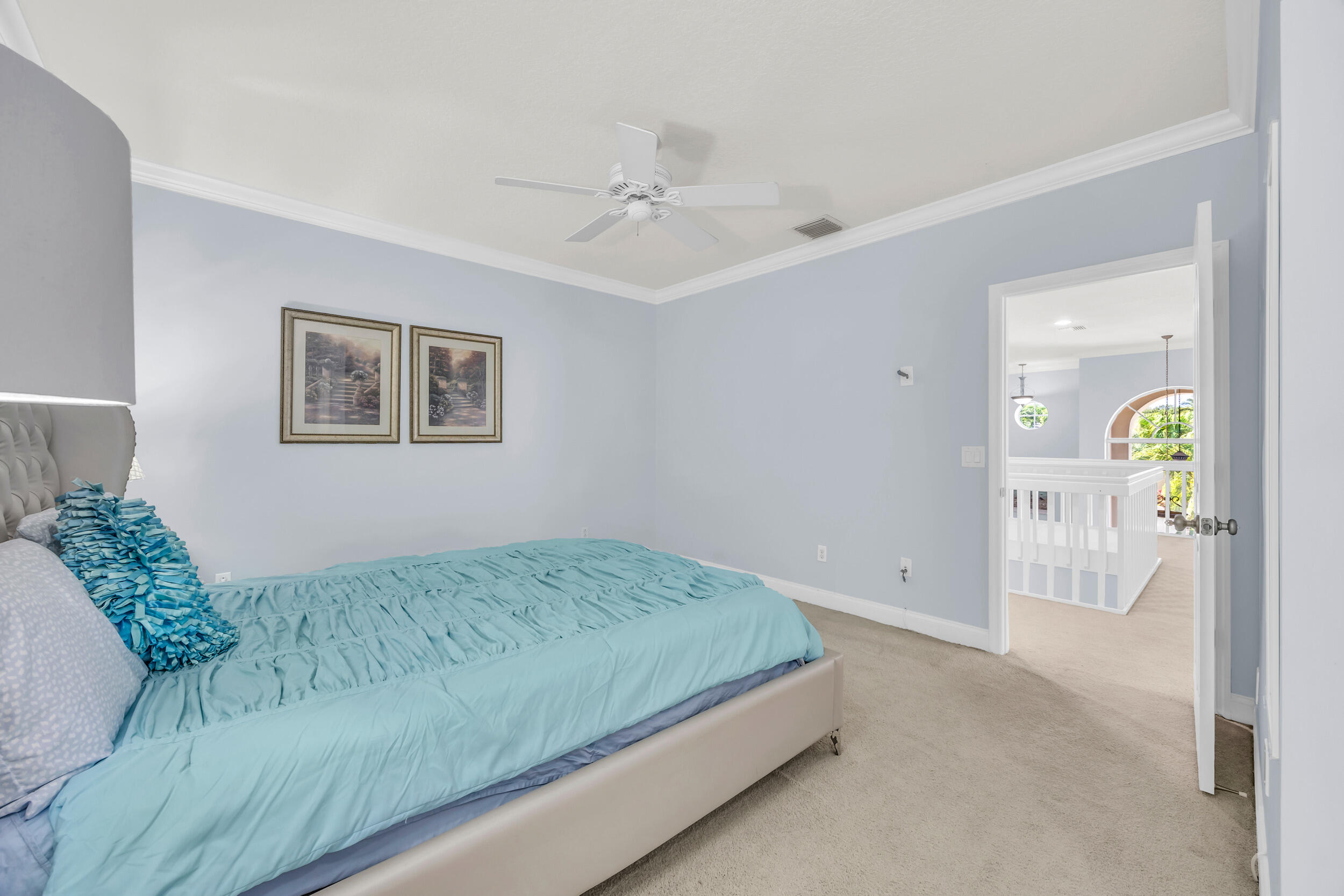 148 Cypress Cove Jupiter, FL 33458 - Photo 45 of 53 a bedroom with a bed and a chandelier