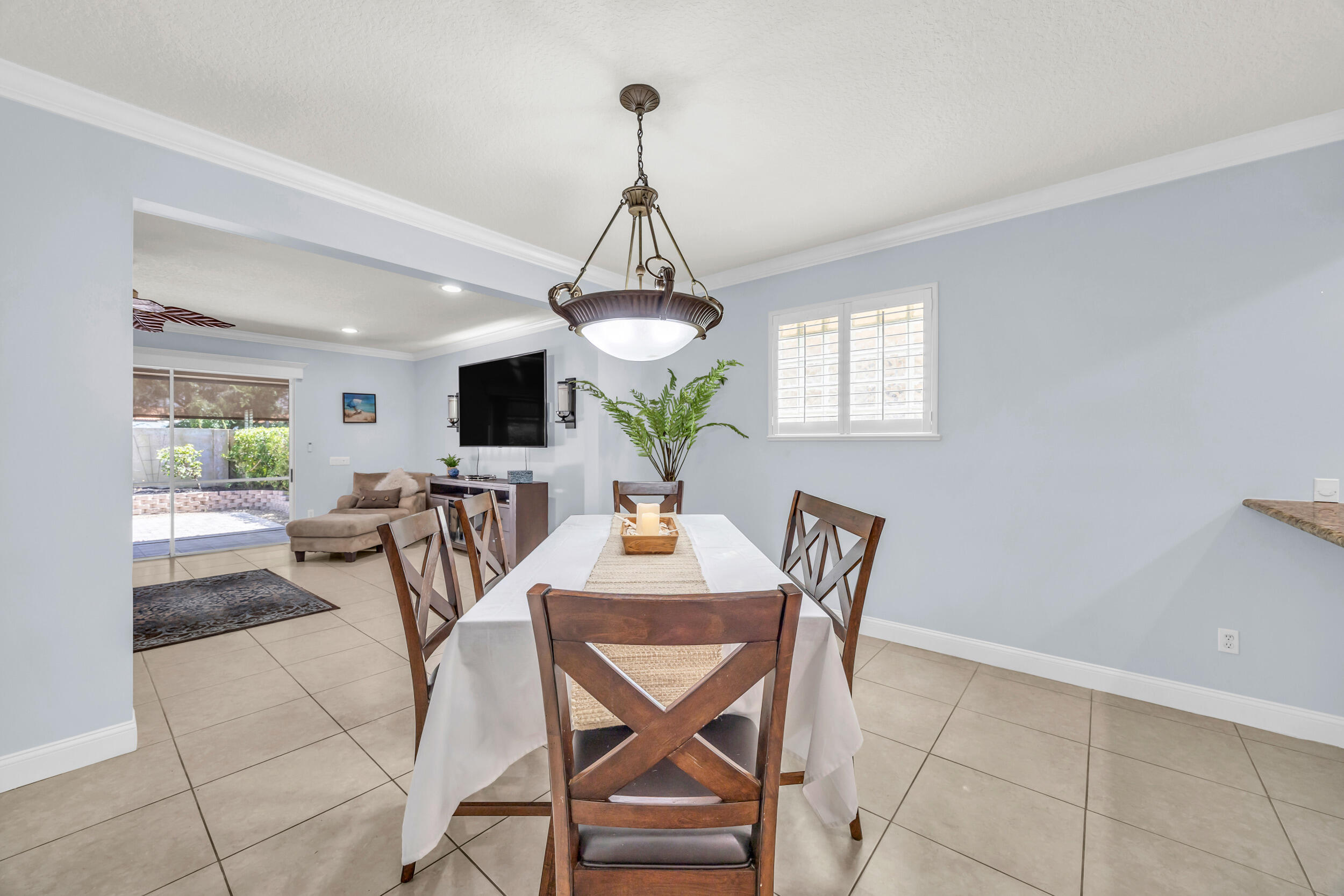 148 Cypress Cove Jupiter, FL 33458 - Photo 10 of 53 a dining room with furniture a window and wooden floor