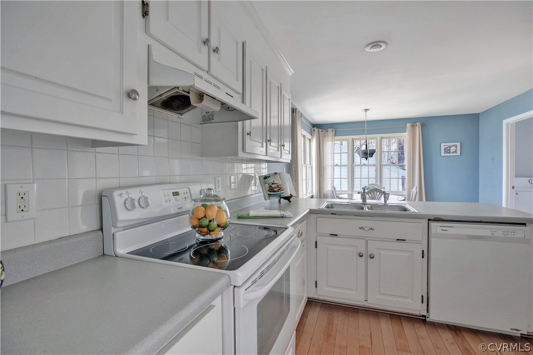 2300 Brookforest Road Midlothian, VA 23112 - Photo 8 of 29 a kitchen with a sink dishwasher and white cabinets with wooden floor