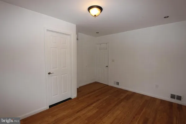 a view of room with wooden floor