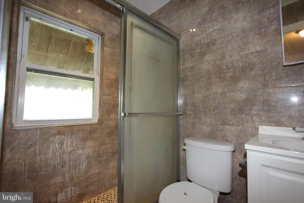 a white toilet sitting next to a bathroom sink
