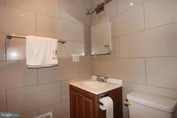 a bathroom with a sink toilet and vanity